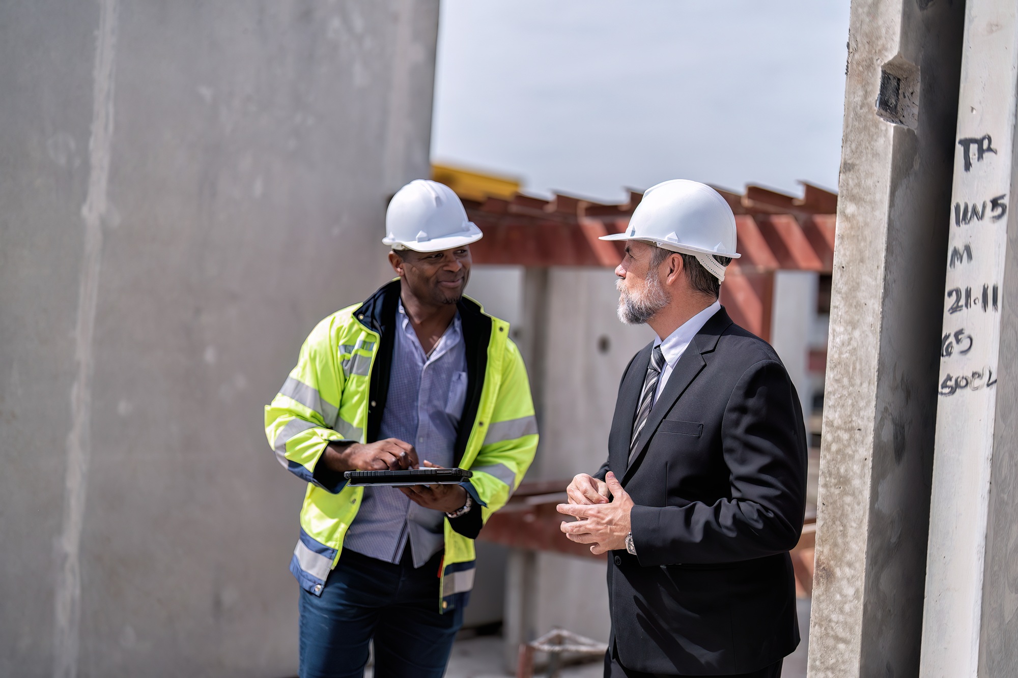 At construction site manager meet senior civil engineer check project work progress and signature