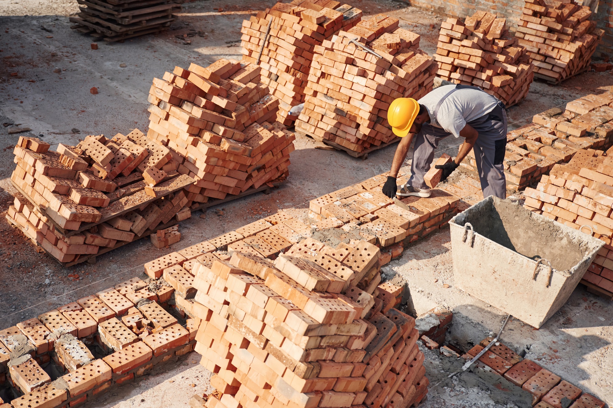 Top view. Handsome Indian man is on the construction site